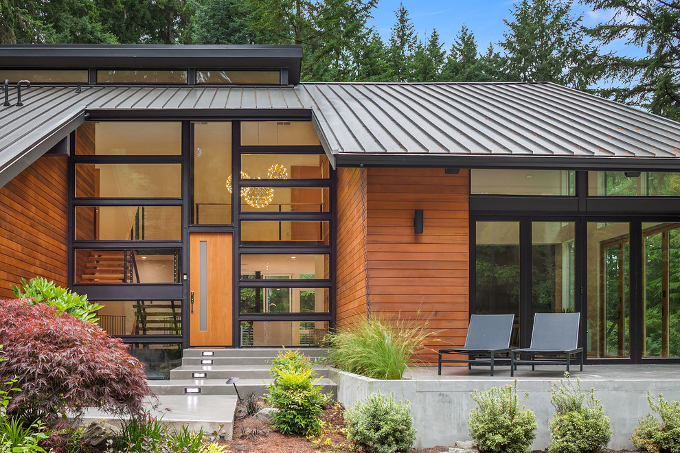 Trendy multicolored three-story wood house exterior photo in Seattle with a shed roof and a metal roof