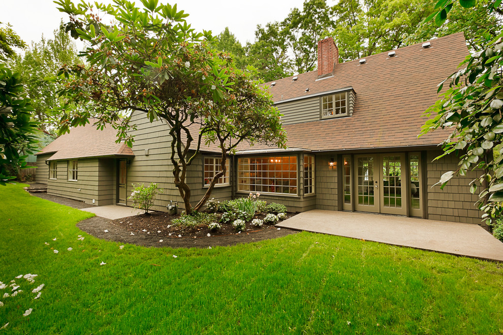 Example of a mid-sized classic green two-story wood gable roof design in Portland