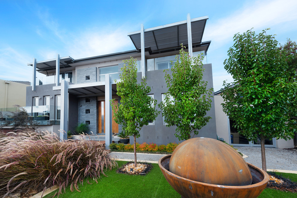 Großes, Zweistöckiges Modernes Einfamilienhaus mit grauer Fassadenfarbe und Flachdach in Melbourne