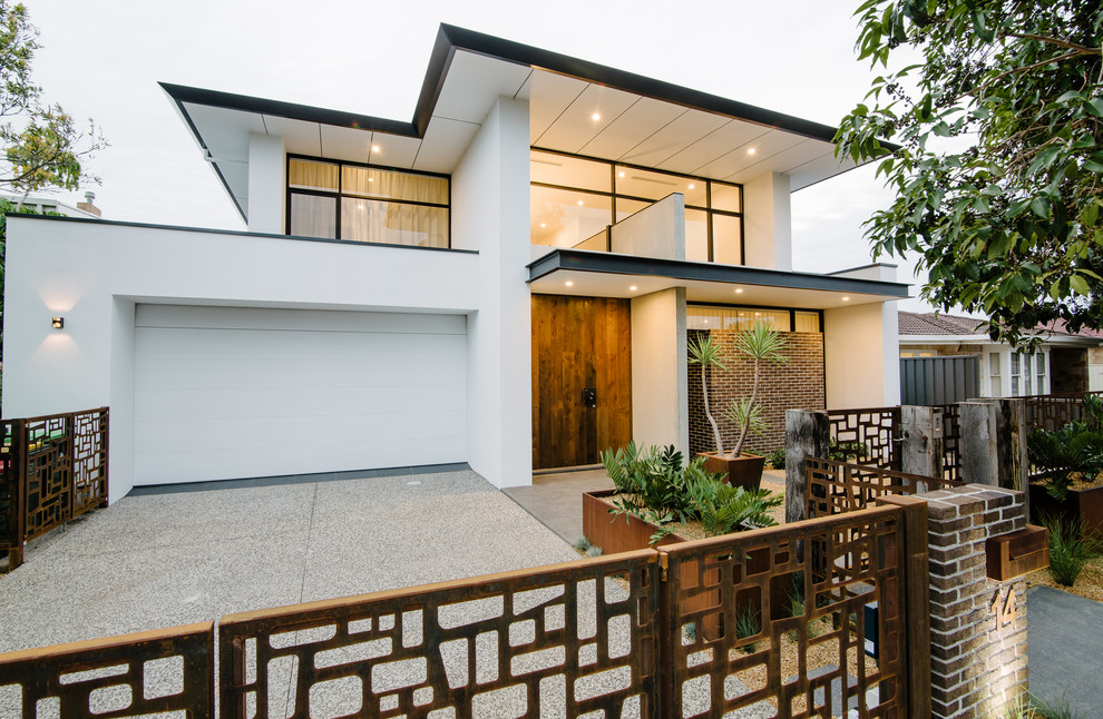 Example of a large trendy white two-story mixed siding flat roof design in Adelaide