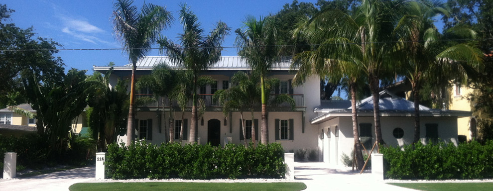 Modelo de fachada blanca exótica grande de dos plantas con revestimiento de estuco y tejado a doble faldón