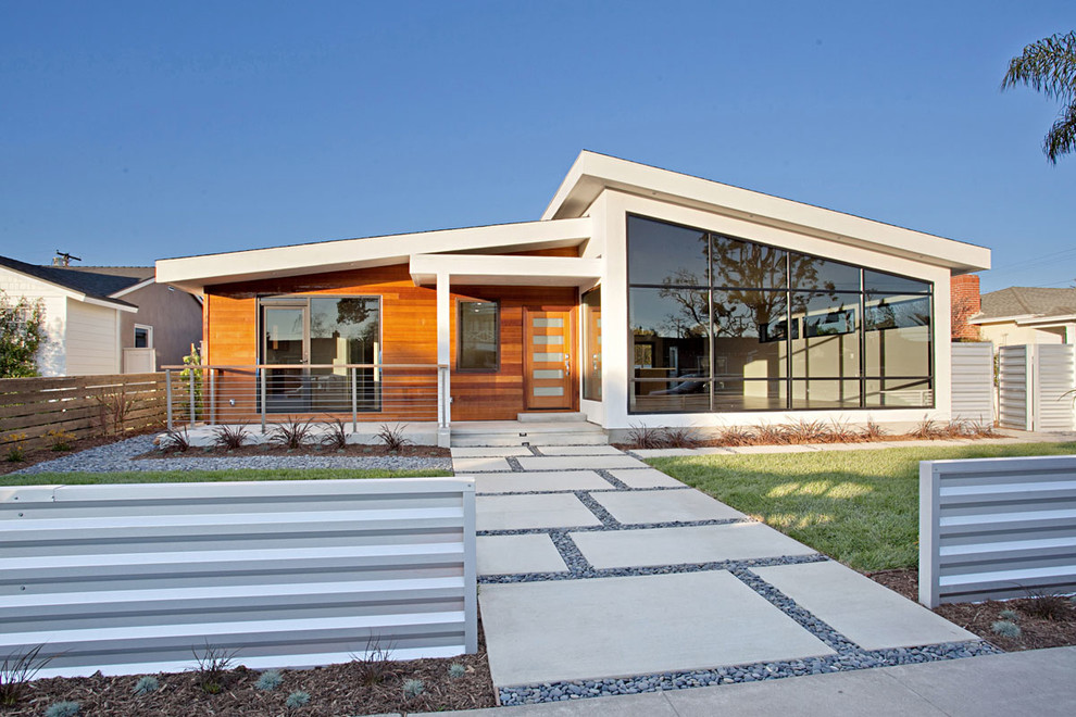 Example of a large trendy white one-story wood exterior home design in Orange County