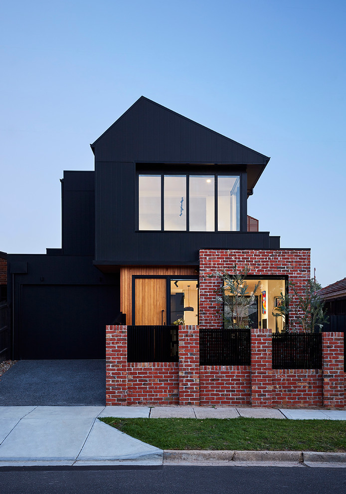 Immagine della villa nera contemporanea a due piani di medie dimensioni con rivestimento in legno, tetto a capanna e copertura in metallo o lamiera