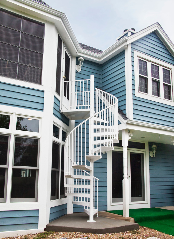Ejemplo de fachada de casa azul costera grande de dos plantas con revestimiento de vinilo y tejado a dos aguas