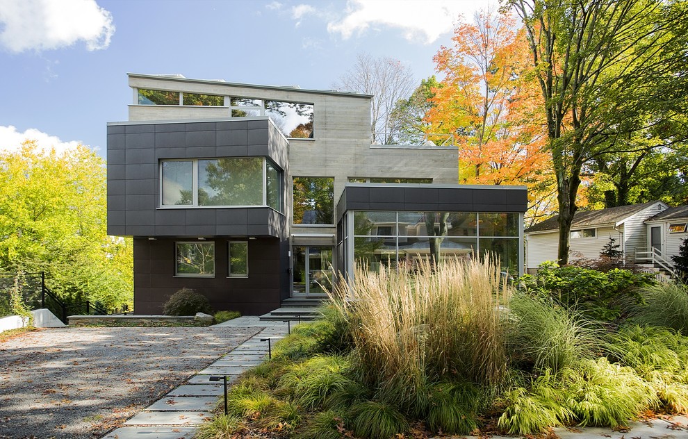 Medium sized and brown contemporary house exterior in Boston with three floors, mixed cladding and a lean-to roof.