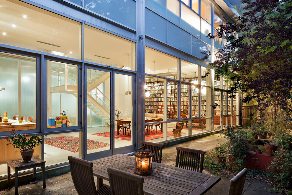 Example of an urban glass exterior home design in New York