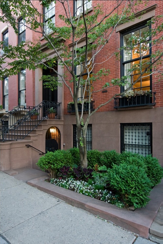 Design ideas for a large and red classic brick house exterior in New York with three floors.