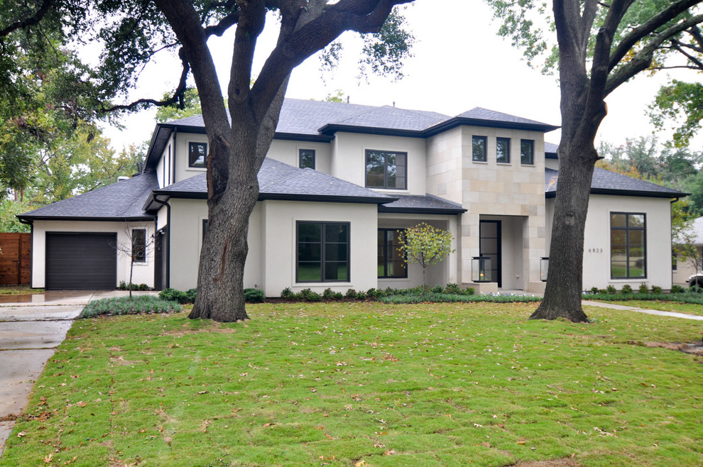 Example of a large transitional white two-story stucco exterior home design in Dallas