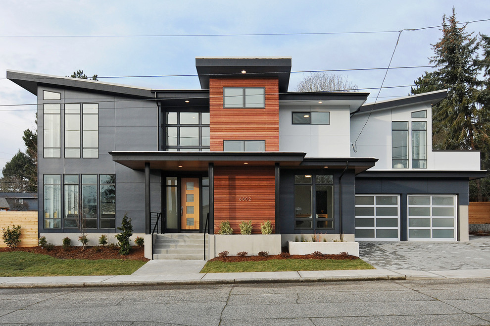 Large and gey contemporary two floor detached house in Seattle with mixed cladding and a flat roof.
