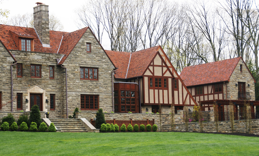 Traditional house exterior in Philadelphia with stone cladding and a red roof.