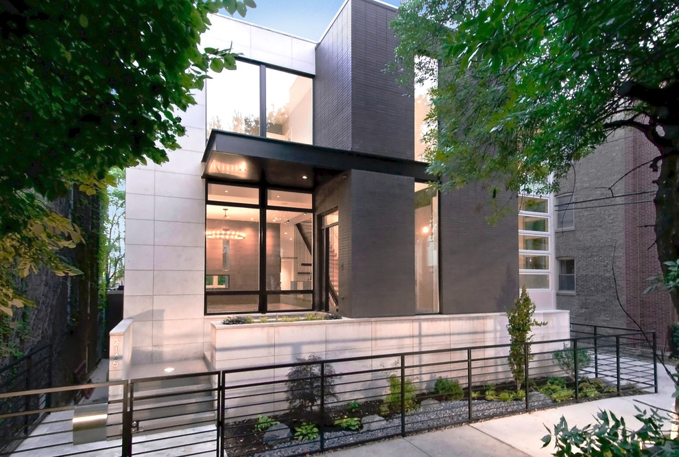 Zweistöckiges, Mittelgroßes Modernes Einfamilienhaus mit Backsteinfassade, grauer Fassadenfarbe und Flachdach