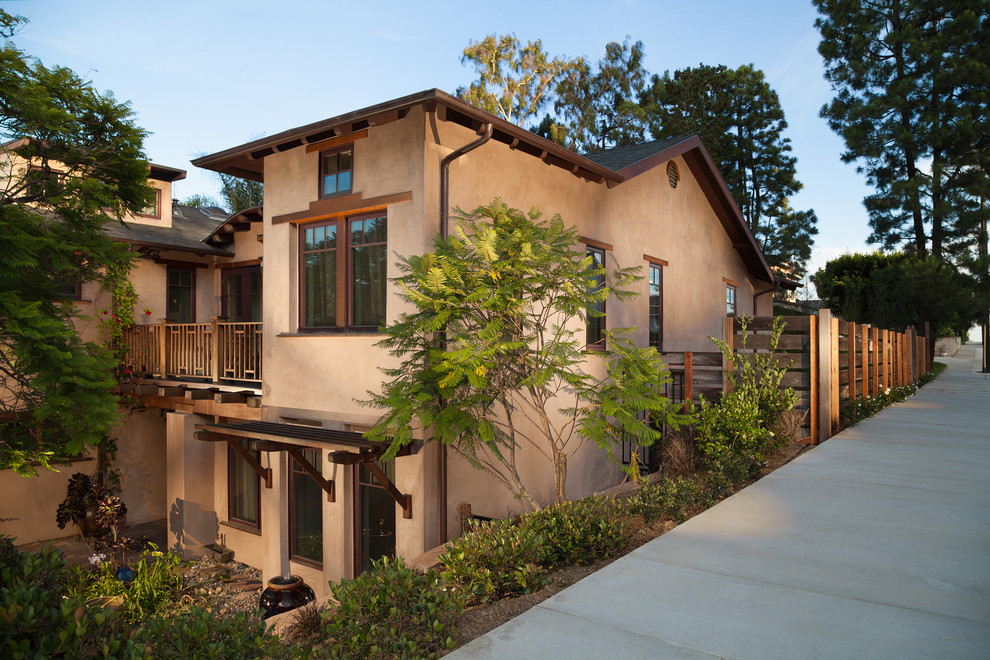 Mid-sized craftsman brown two-story stucco exterior home idea in Orange County