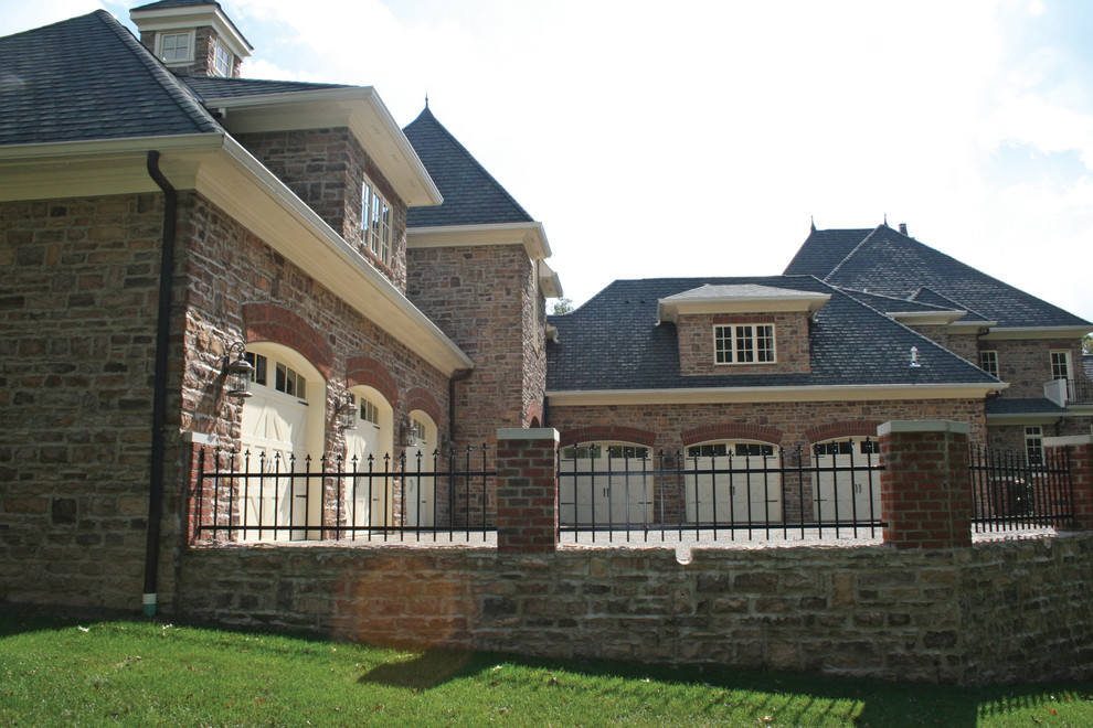 Huge elegant beige three-story stone house exterior photo in Columbus with a hip roof and a shingle roof