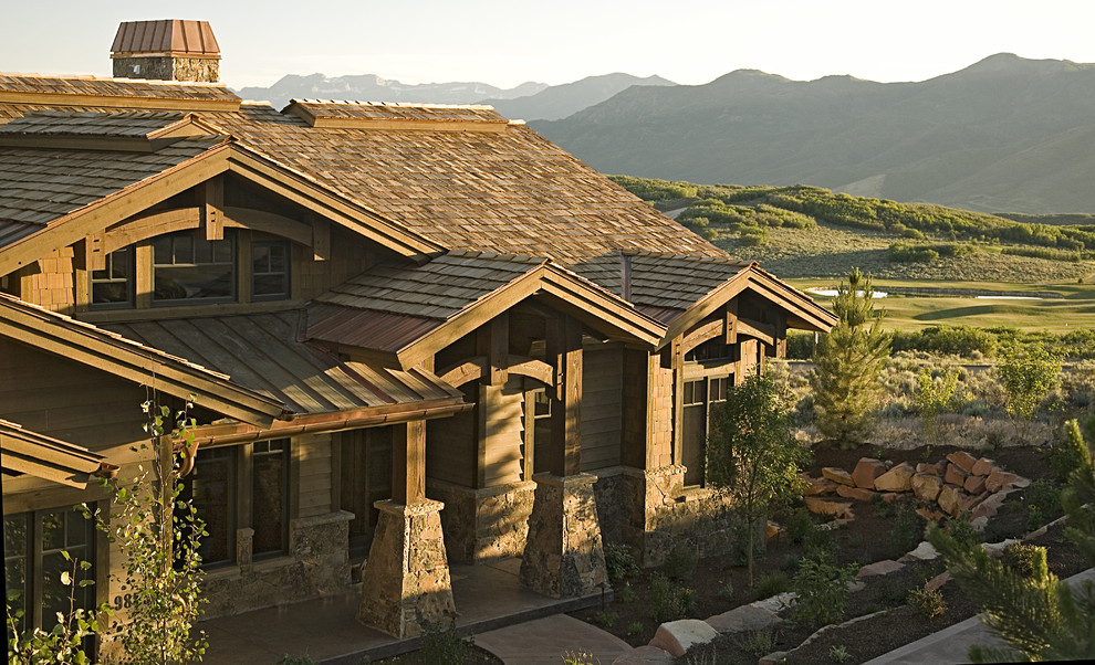 Inspiration for a contemporary house exterior in Salt Lake City with stone cladding and a mixed material roof.