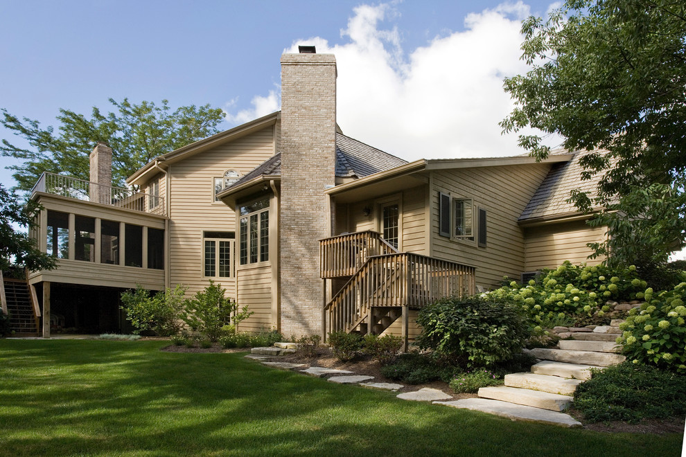 Inspiration for a large timeless beige two-story wood gable roof remodel in Chicago