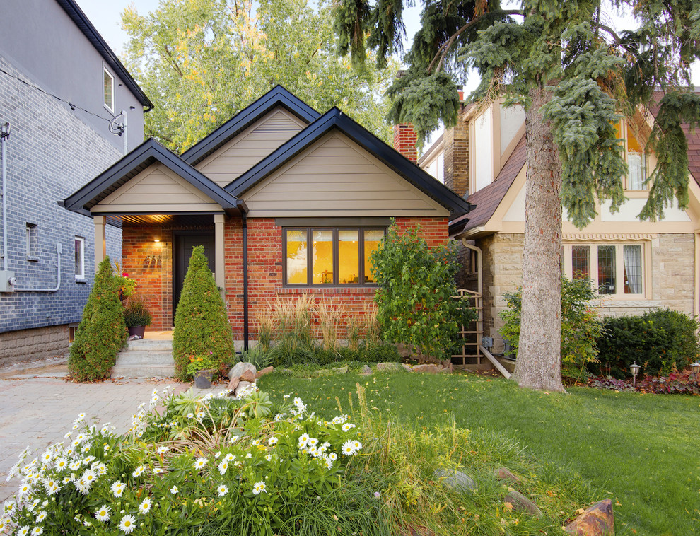 Design ideas for a small and red classic bungalow brick house exterior in Toronto with a pitched roof.