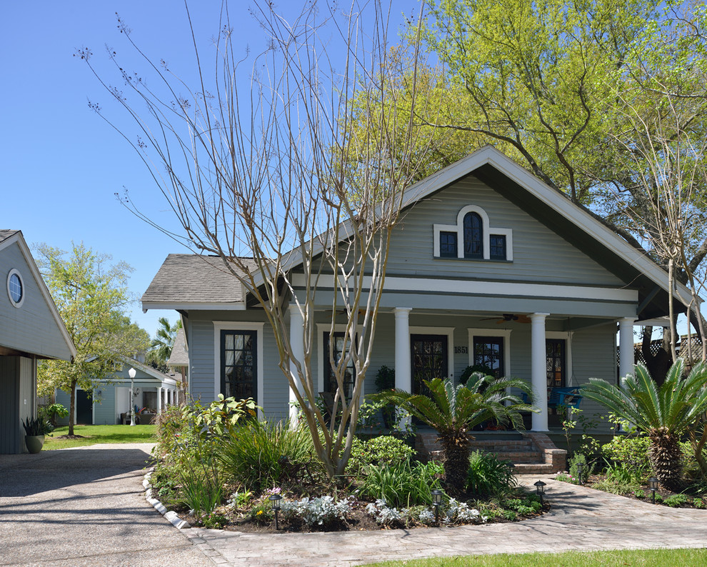 Example of a mid-sized arts and crafts gray one-story wood gable roof design in Houston