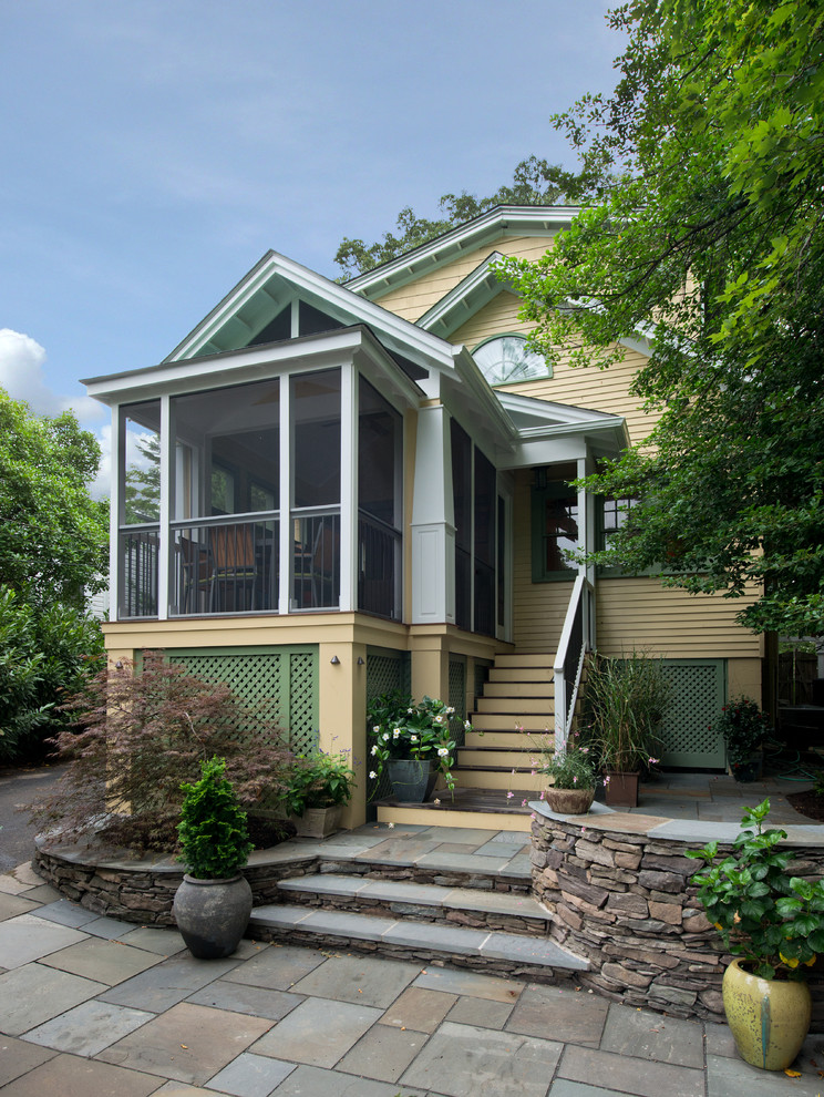 Arts and crafts yellow exterior home photo in DC Metro
