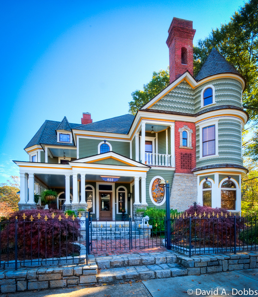 Photo of a medium sized and green victorian house exterior in Atlanta with three floors and wood cladding.