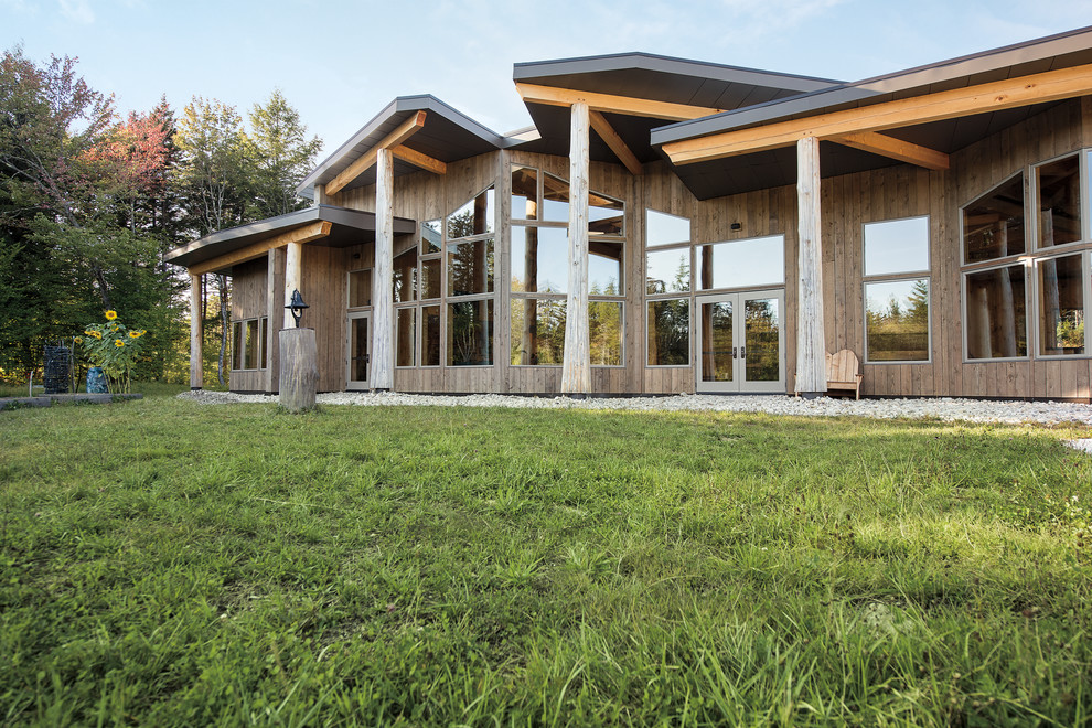 Huge eclectic beige wood exterior home idea in Burlington