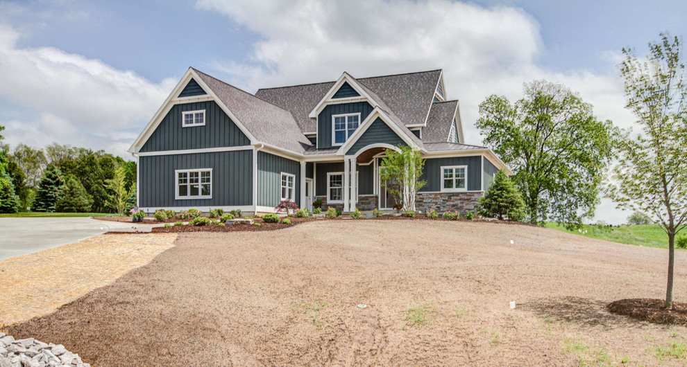 Example of a large arts and crafts blue two-story wood exterior home design in Grand Rapids