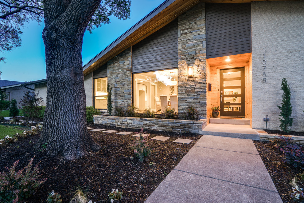 Photo of a white midcentury bungalow brick house exterior in Dallas.