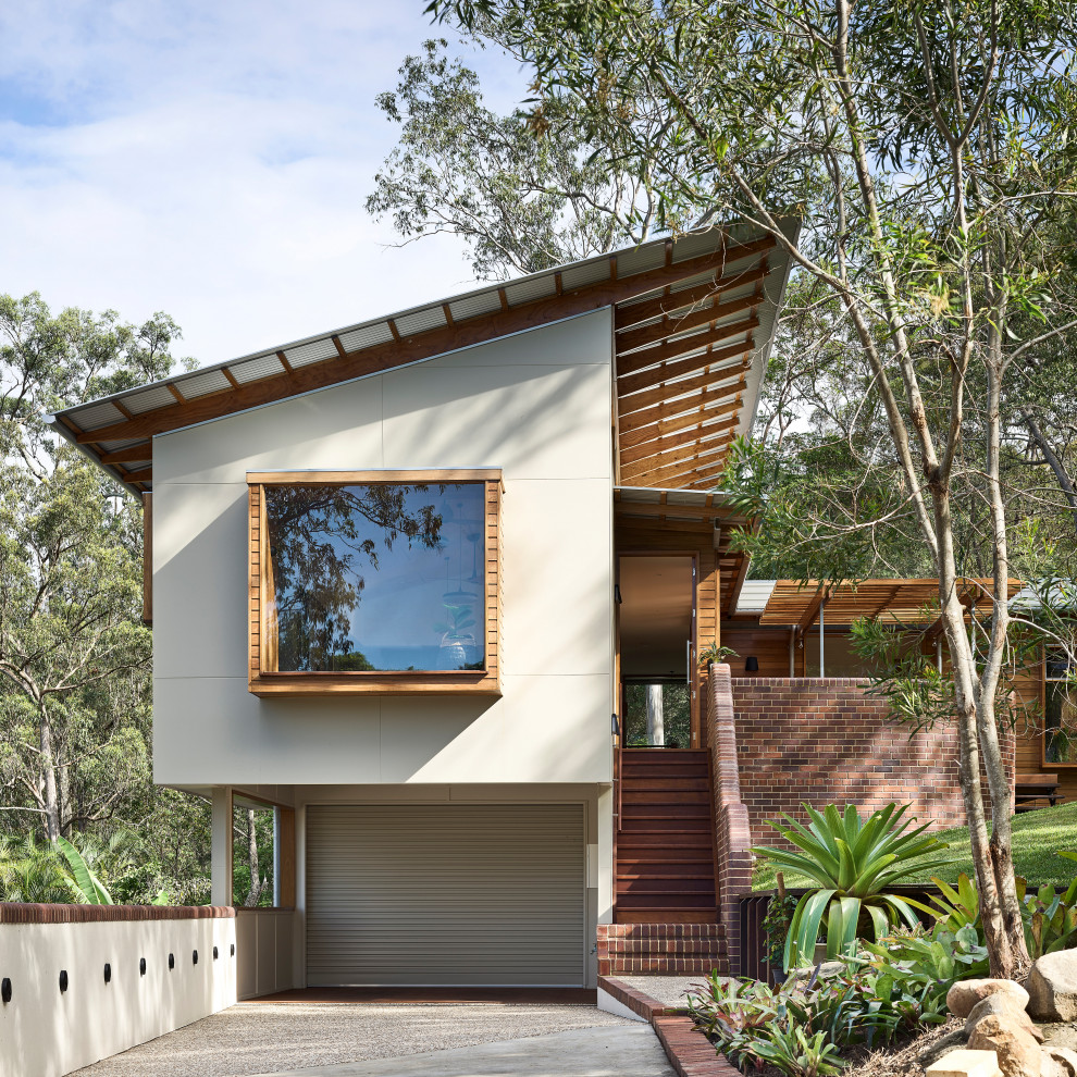 Contemporary white house exterior idea in Brisbane with a shed roof