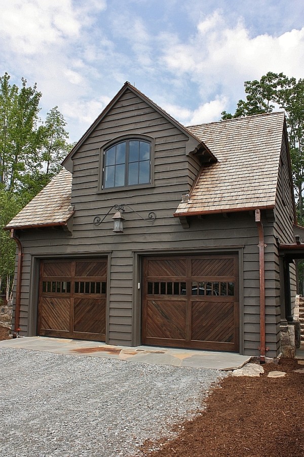 Esempio della facciata di una casa marrone rustica a due piani di medie dimensioni con rivestimento in legno e tetto a capanna