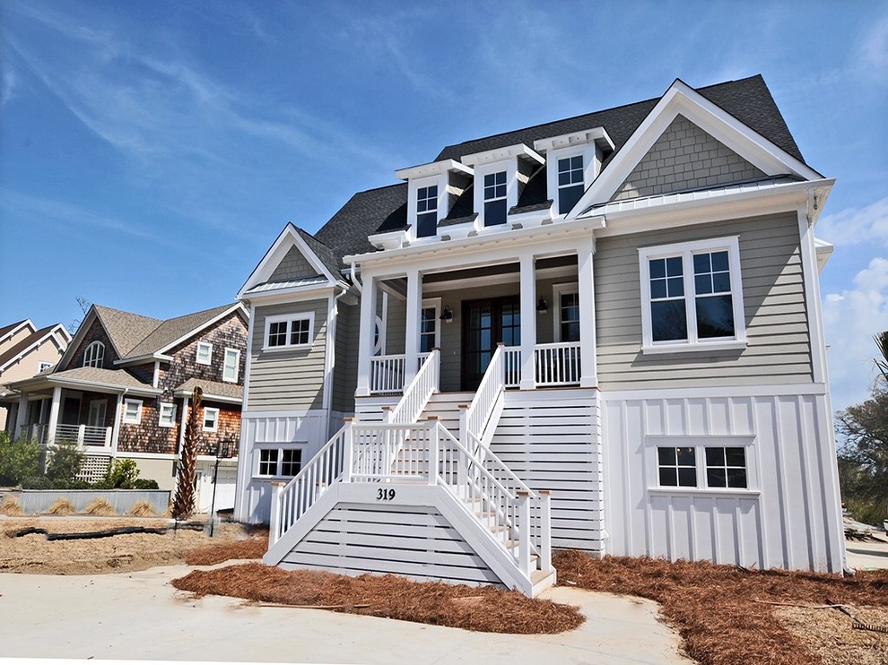 Example of a mid-sized beach style gray two-story vinyl exterior home design in Wilmington with a shingle roof
