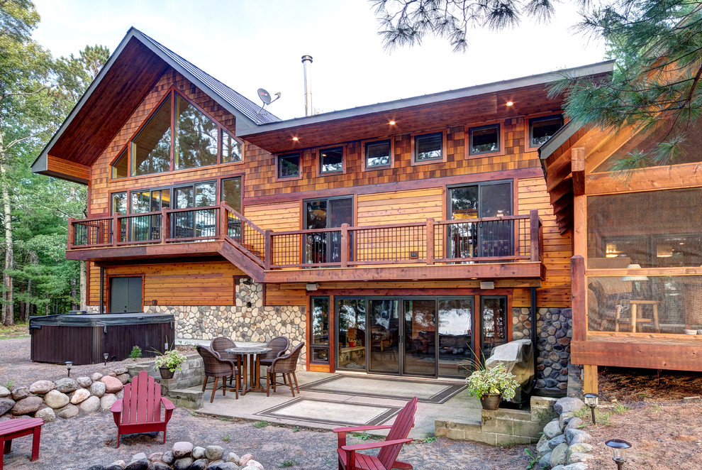 Example of a mountain style three-story mixed siding exterior home design in Other with a metal roof
