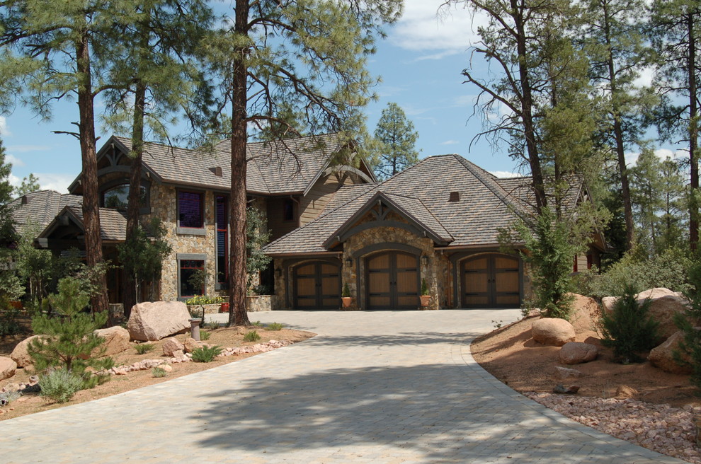 Example of a huge arts and crafts beige two-story wood gable roof design in Phoenix