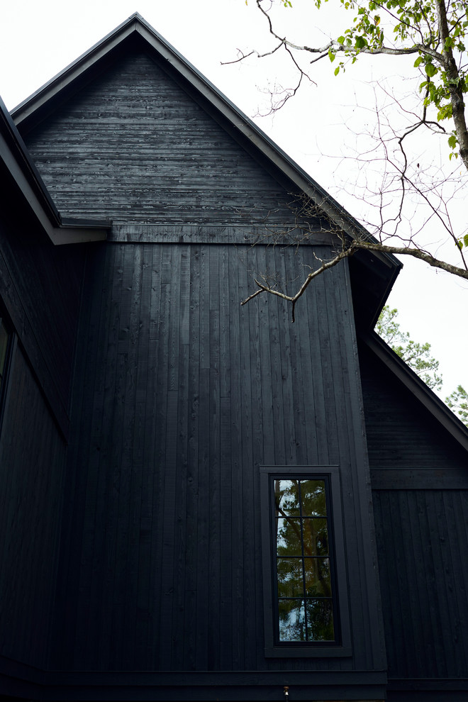 Foto de fachada de casa negra rural grande de dos plantas con revestimiento de madera, tejado a dos aguas y tejado de metal