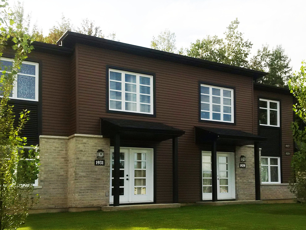 Inspiration for a modern two-story vinyl exterior home remodel in Other