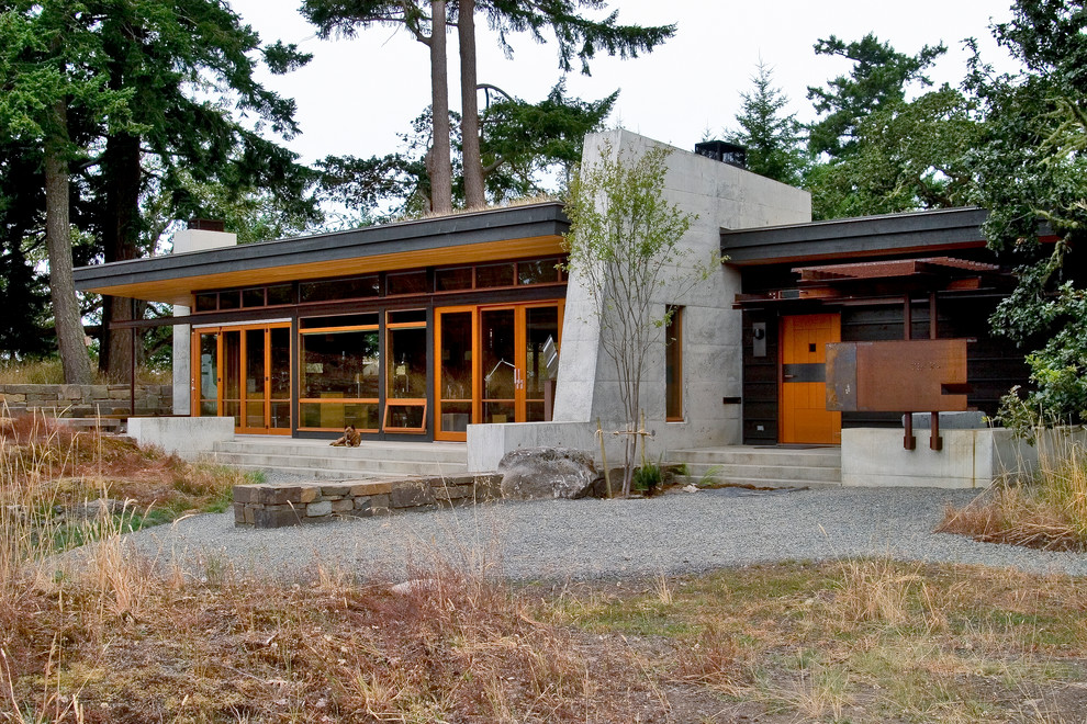 Photo of a small and multi-coloured contemporary bungalow house exterior in Seattle with a flat roof and mixed cladding.