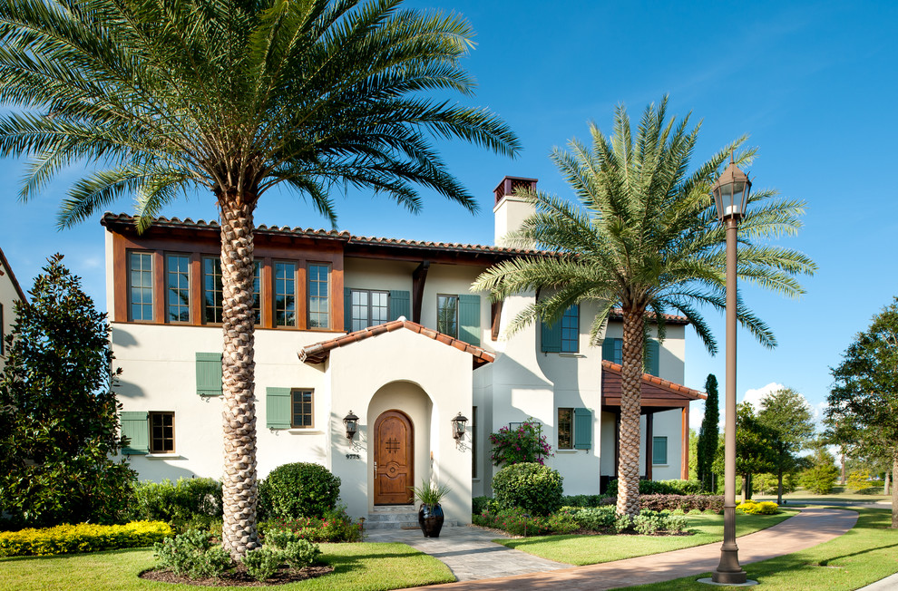 Inspiration for a white mediterranean two floor render house exterior in Orlando.