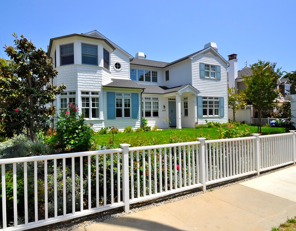 Cette photo montre une façade de maison blanche bord de mer en bois à un étage.