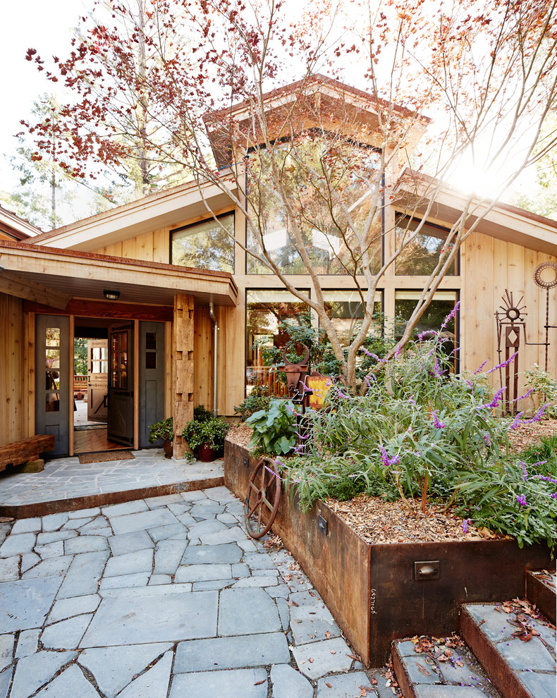 This is an example of a rustic bungalow house exterior in San Francisco with wood cladding and a pitched roof.