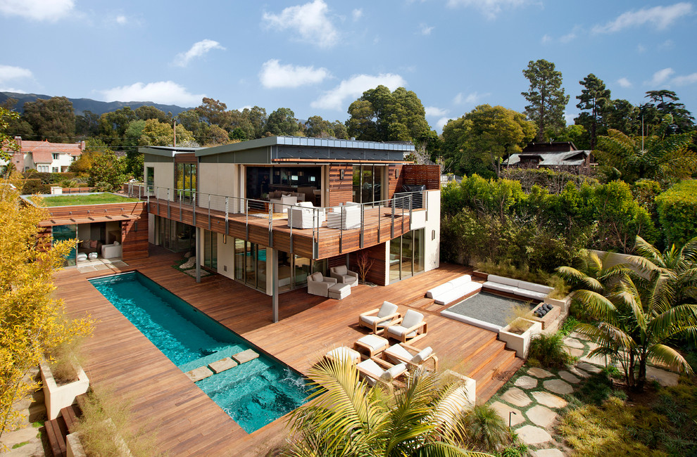 Mid-sized trendy white two-story mixed siding exterior home photo in Santa Barbara with a shed roof