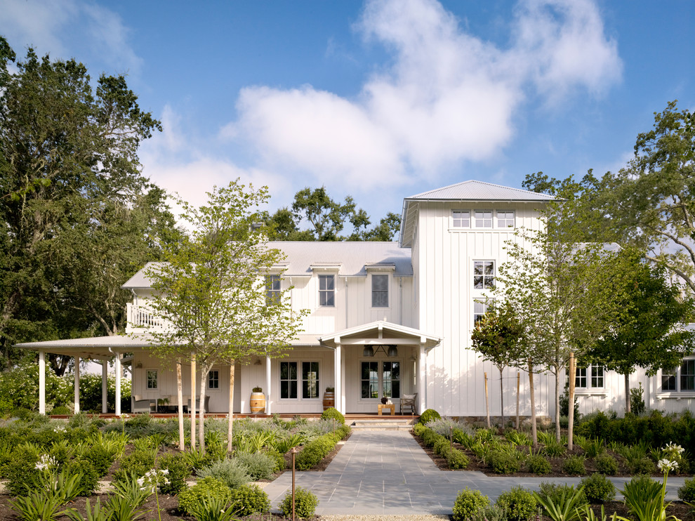 Inspiration for a white country two floor house exterior in San Francisco with wood cladding.