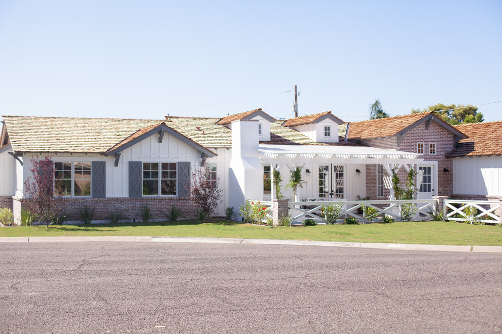Example of a large classic white one-story mixed siding gable roof design in Phoenix