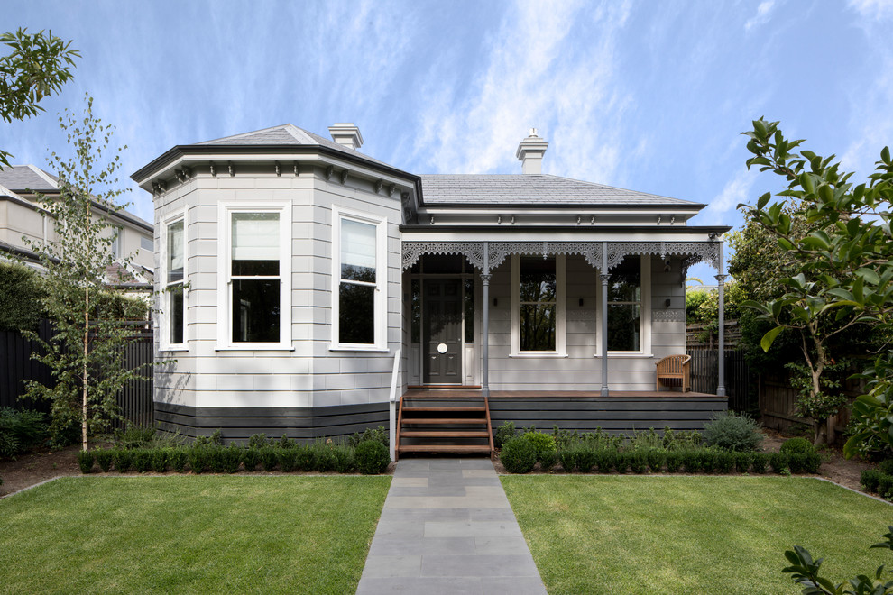 Cette photo montre une grande façade de maison grise victorienne en bois de plain-pied avec un toit à quatre pans et un toit en shingle.