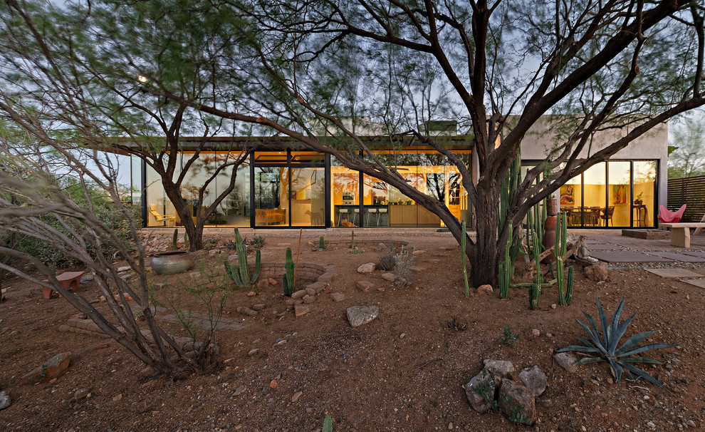 Photo of a large modern bungalow glass house exterior in Phoenix with a flat roof.
