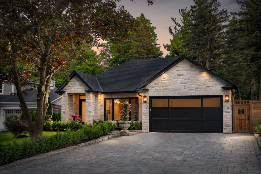Medium sized and gey classic bungalow detached house in Toronto with stone cladding, a shingle roof and a pitched roof.