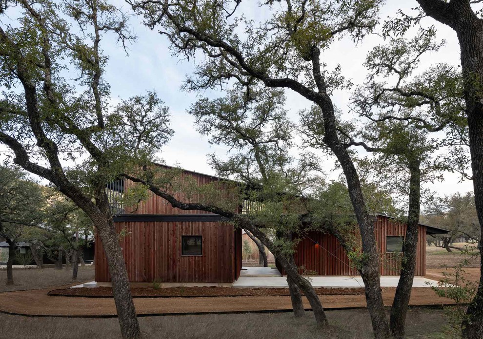 Inspiration for a red rustic detached house in Austin with wood cladding and a metal roof.