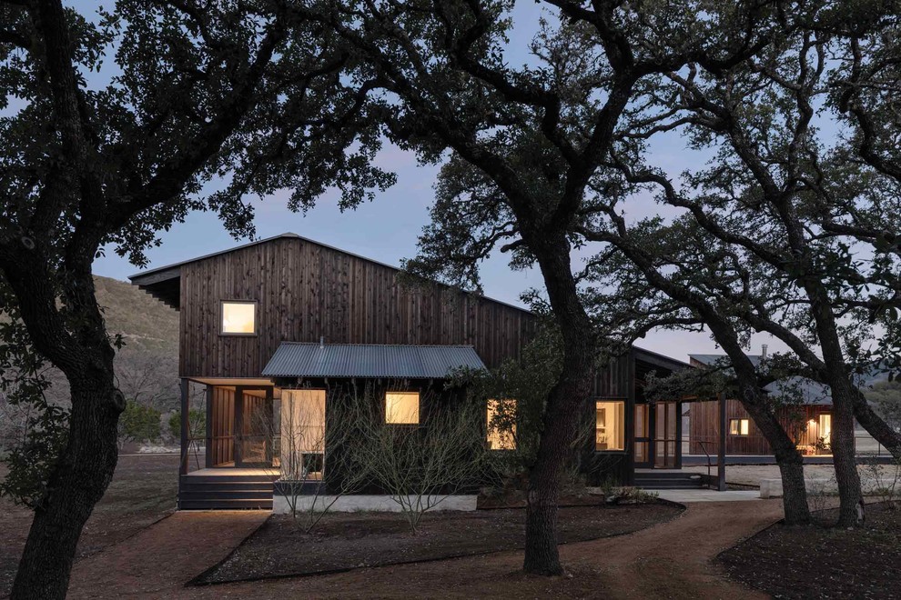 Design ideas for a brown rustic two floor detached house in Austin with wood cladding, a lean-to roof and a metal roof.