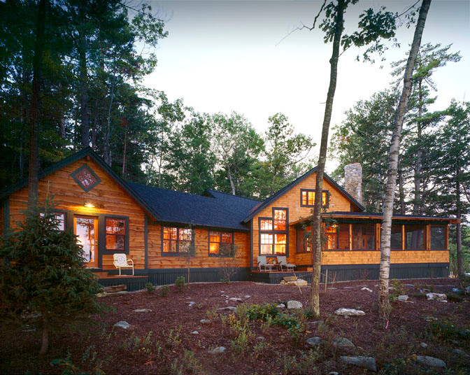Inspiration for a rustic two floor house exterior in Boston with wood cladding.