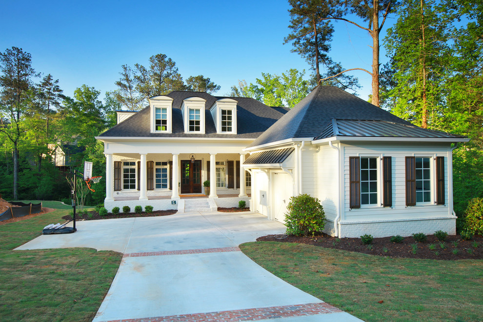 Large elegant white two-story brick exterior home photo in Atlanta