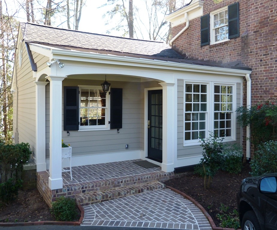Inspiration for a mid-sized timeless beige two-story mixed siding gable roof remodel in Raleigh