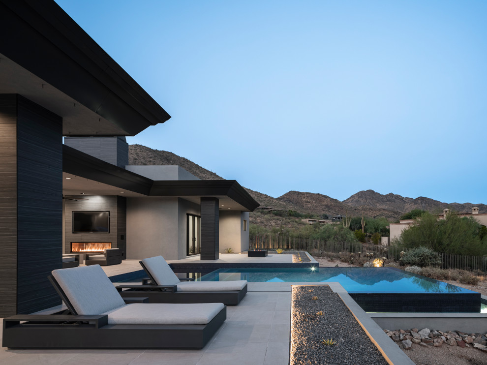 Großes, Einstöckiges Modernes Einfamilienhaus mit Putzfassade, grauer Fassadenfarbe, Flachdach, Blechdach und schwarzem Dach in Phoenix