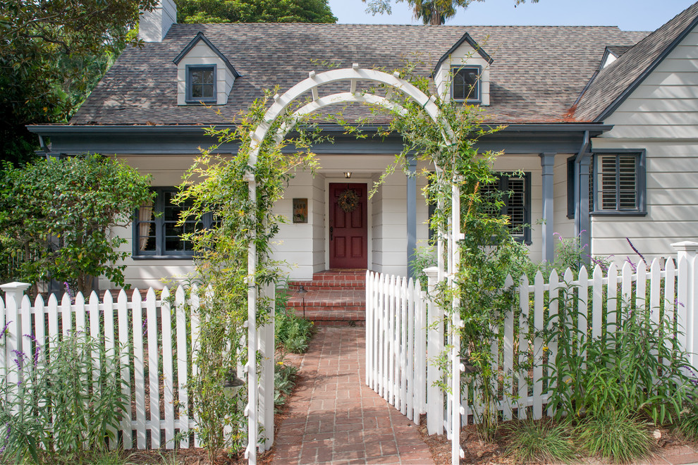 Inspiration for a mid-sized farmhouse white two-story wood gable roof remodel in Los Angeles